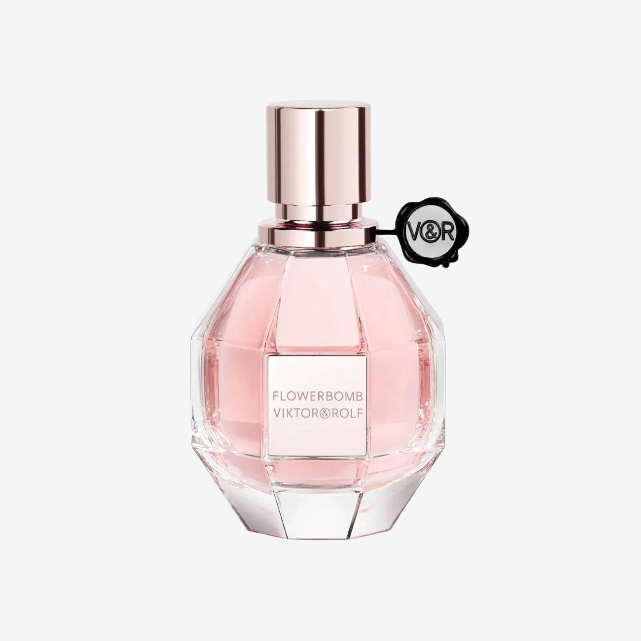 Close-up of Viktor & Rolf Flowerbomb Women EDP 100ml bottle featuring its faceted glass design with pink liquid and signature ribbon accent.